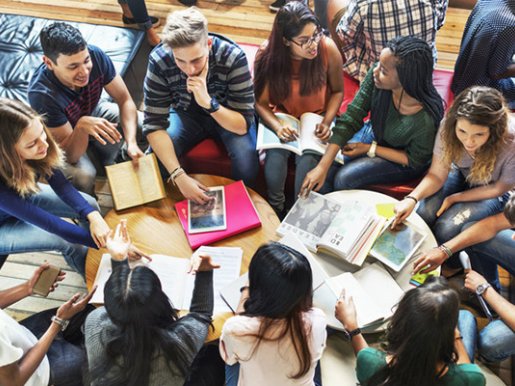 college students sitting in a circle studying and discussing