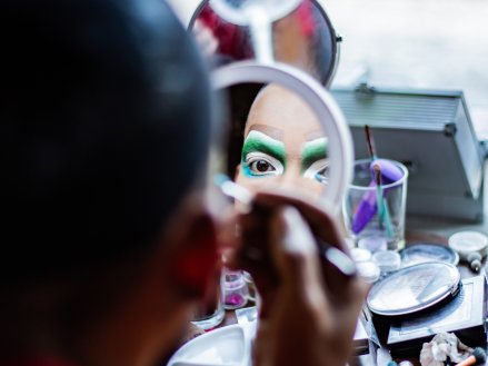 Drag performer putting on makeup